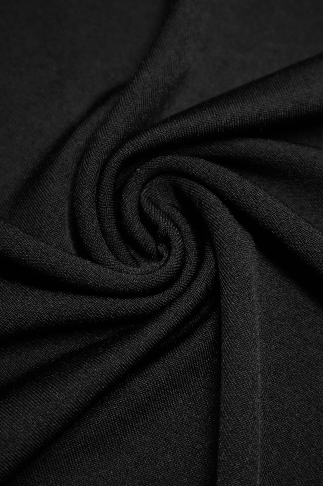Tecido preto Incotex com textura e dobras em espiral